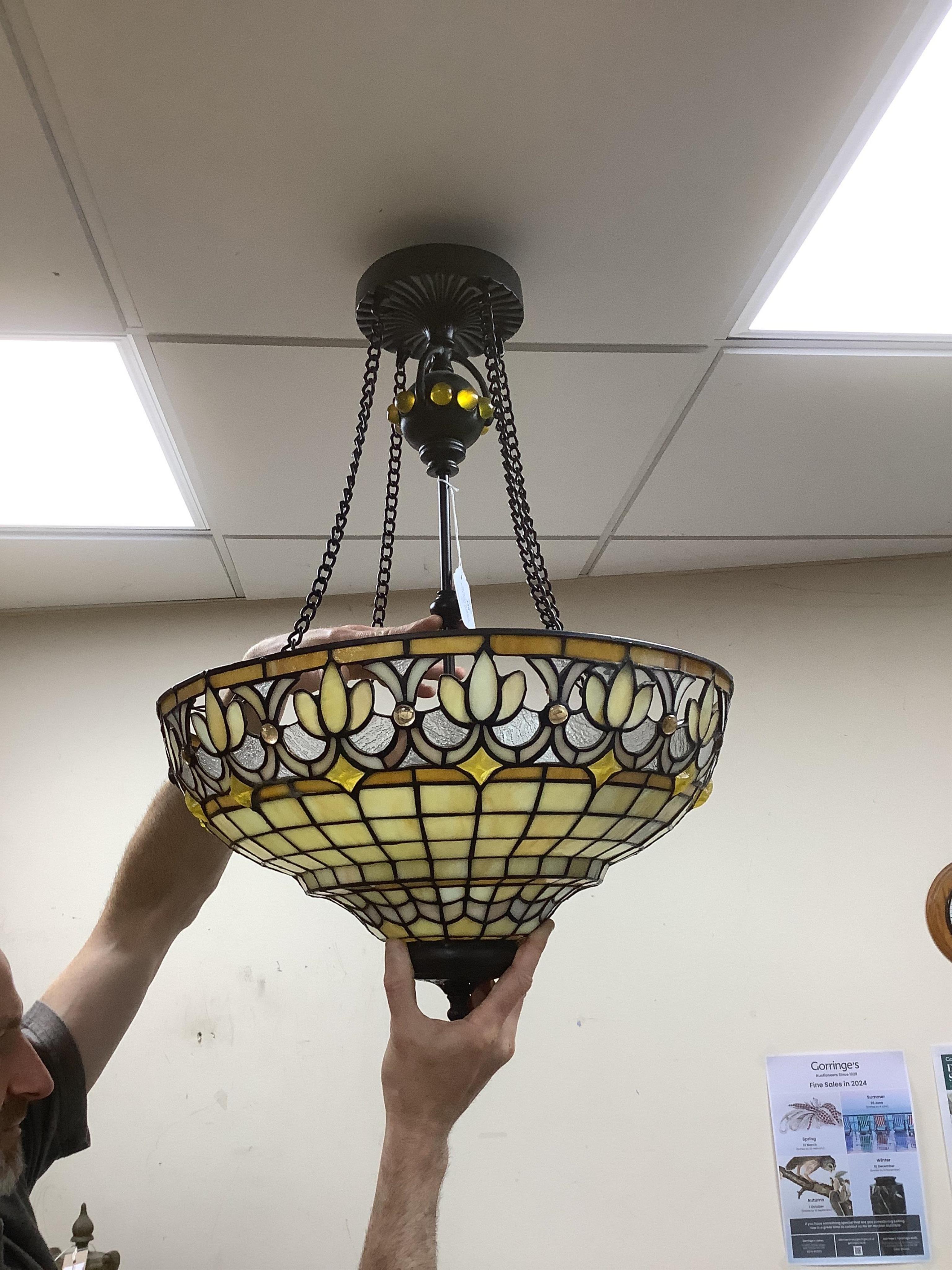 A Tiffany style coloured glass ceiling shade with pendant chains, 63cm high overall. Condition - fair to good.